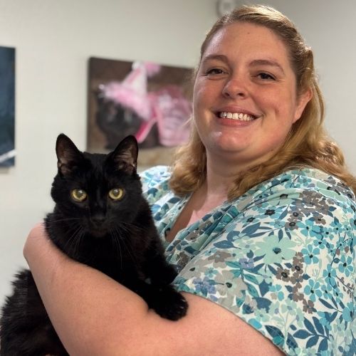 Denise holding a black cat