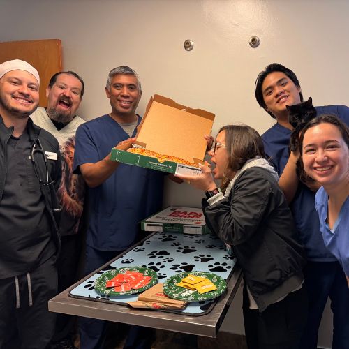 A group of smiling people poses together